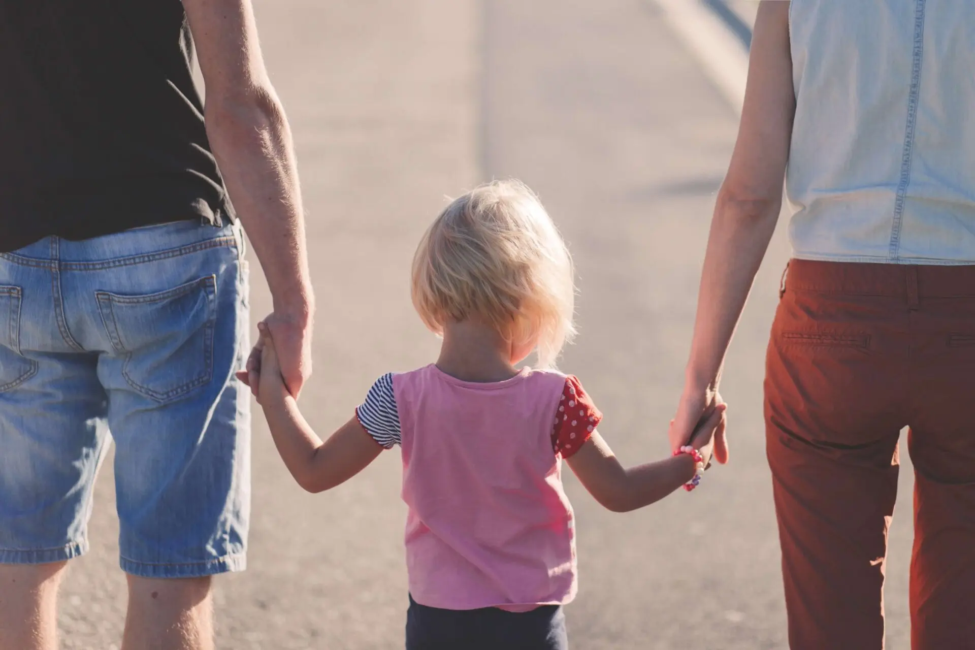 Child walking with parents